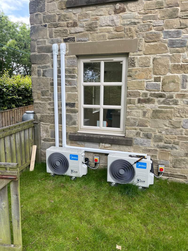 Two outdoor air conditioning units at a stone cottage near Newcastle upon Tyne