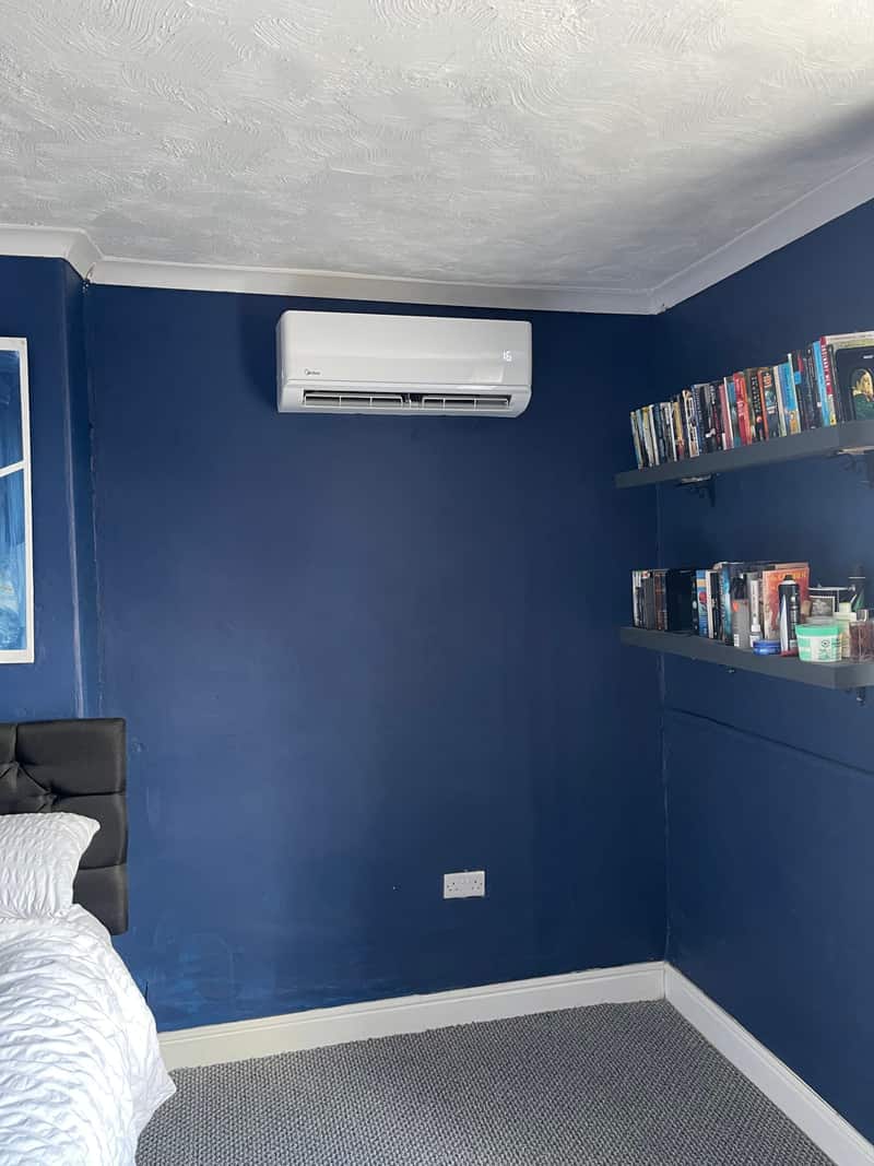 Residential air conditioning unit in a navy blue bedroom in Newcastle upon Tyne