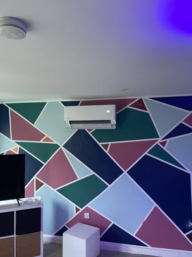 Wall-mounted air conditioner on a geometric feature wall in Newcastle upon Tyne